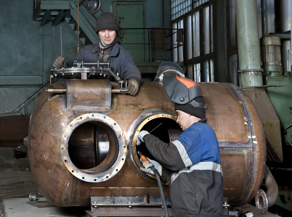 Welder works on factory