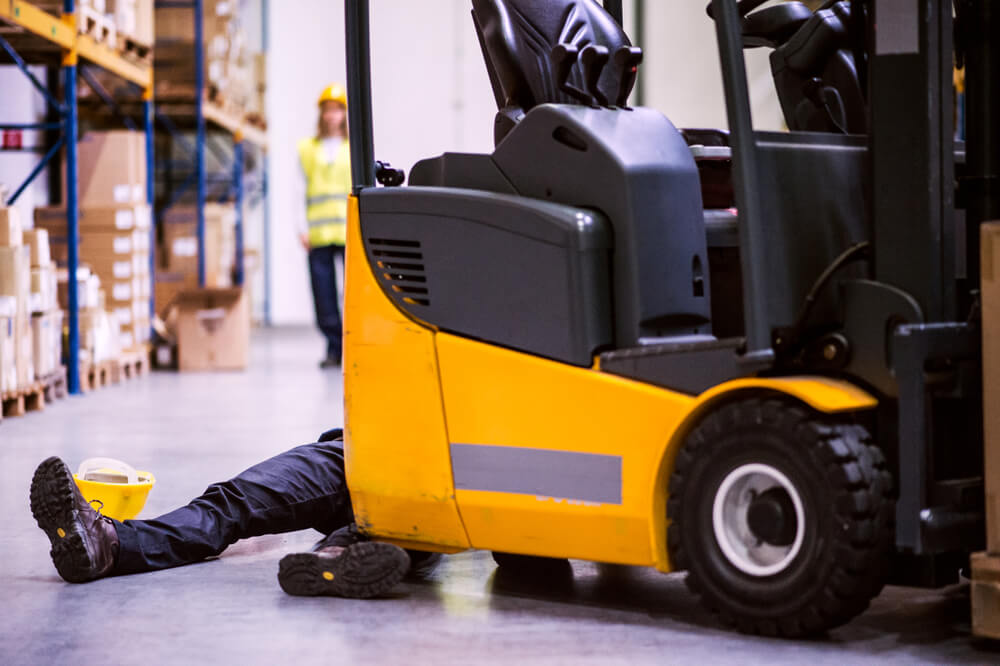 Forklift accident in warehouse with injured worker. Greensboro, NC forklift accident lawyer can help with compensation claims.