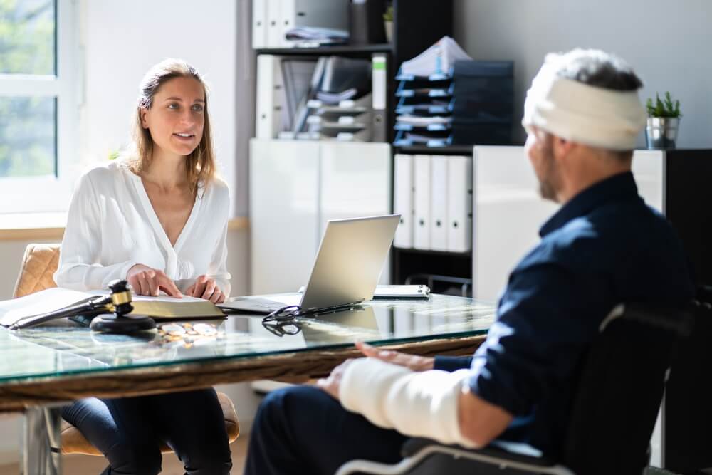 Injured worker meeting with a North Carolina workers’ compensation attorney to discuss settlement timeline