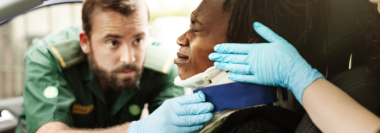 paramedics helping a woman in a car accident