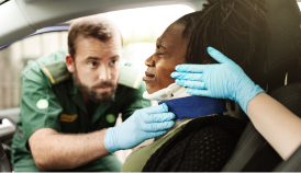 paramedics helping a woman in a car accident