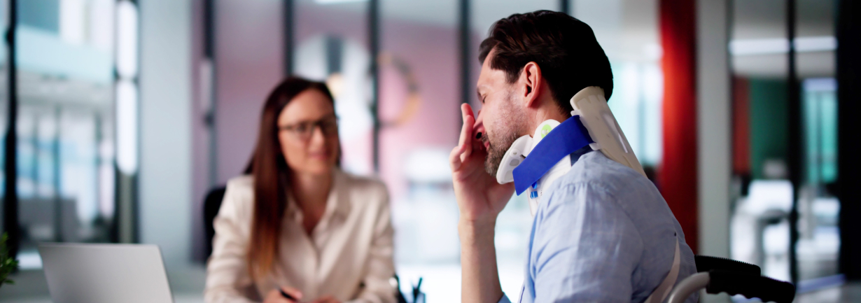 man with an injured neck in consultation with a lawyer