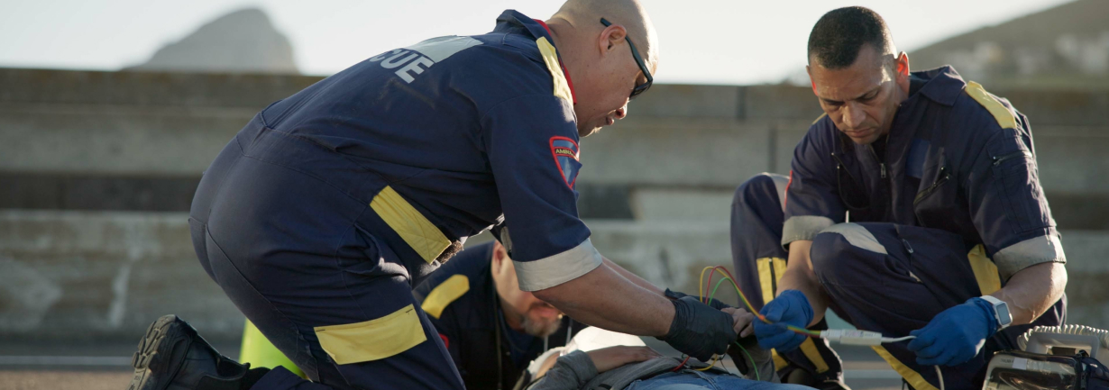 paramedics helping a person in an accident