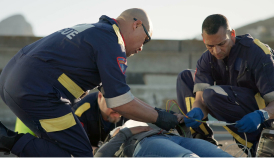 paramedics helping a person in an accident